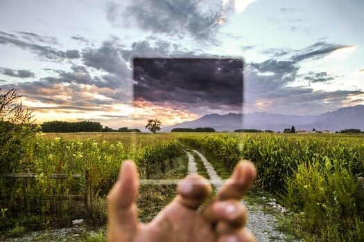 Focusing glass over a trail through green field